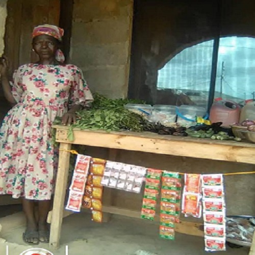 8.Chinyere-Idam-standing-at-the-overflow-table-for-the-rest-of-her-provision-goods